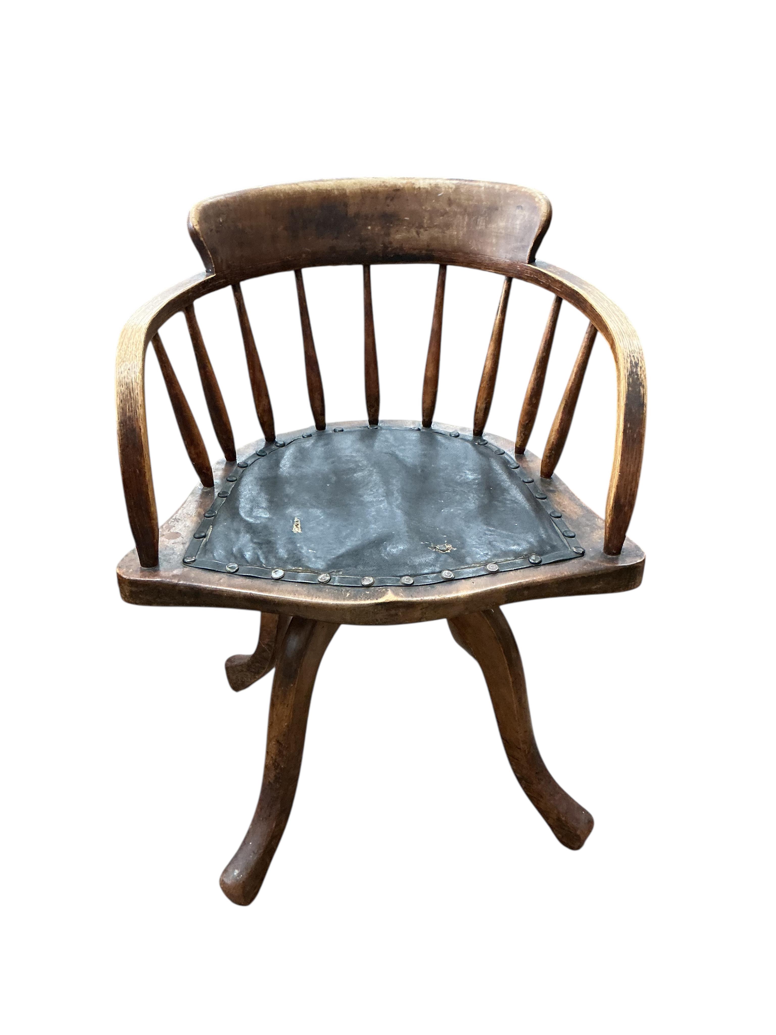 An early 20th century ash and beech revolving desk chair, width 55cm, depth 45cm, height 76cm